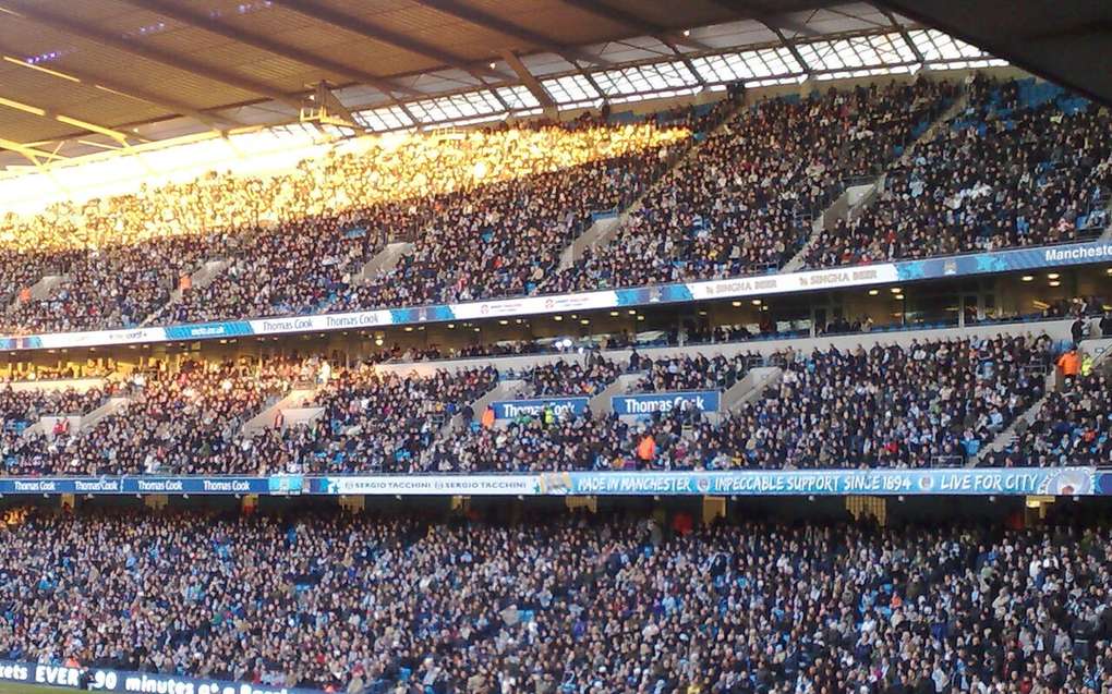 A packed football stadium crowd during a match