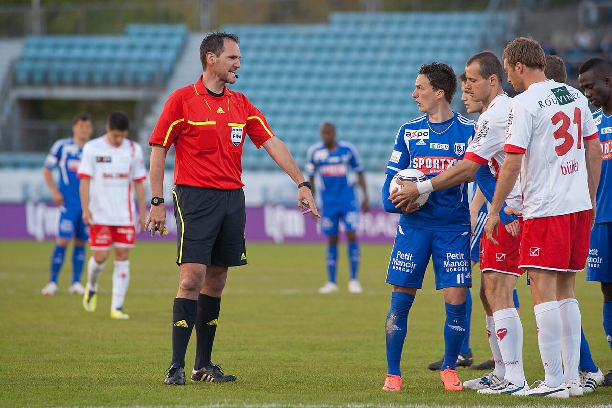 A referee in action during a league match
