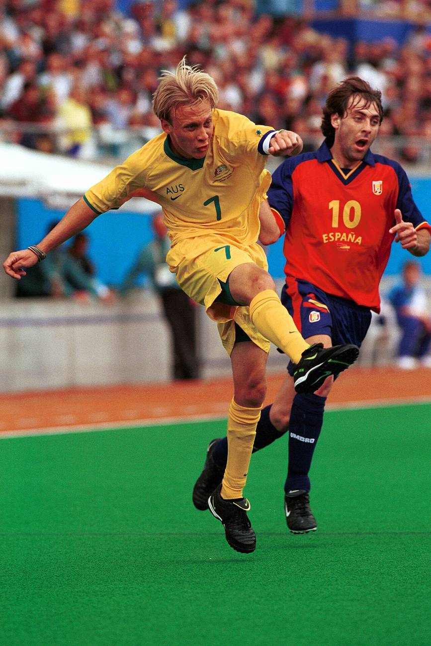 A footballer controlling the ball under pressure in a match