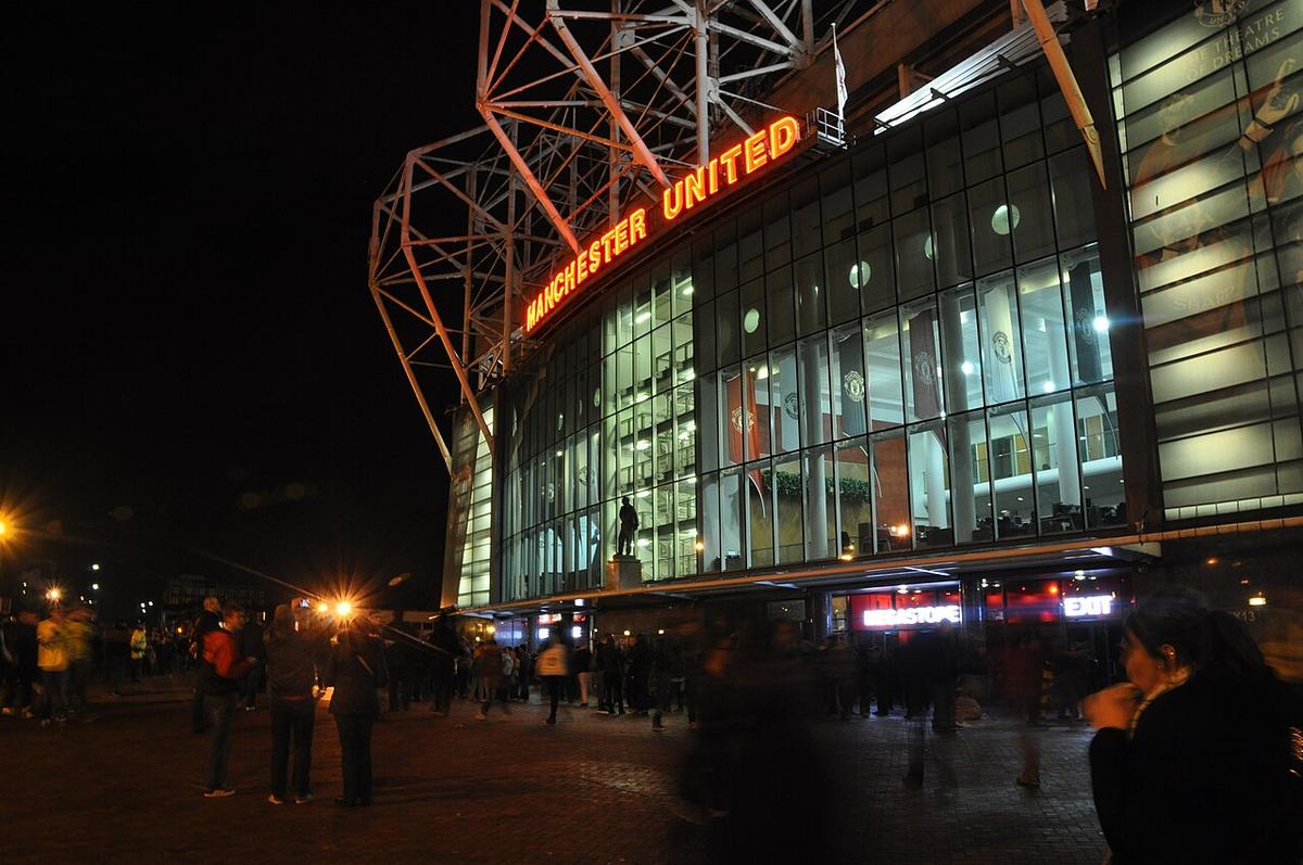 Tribuna exterior de Old Trafford, con aficionados llegando al estadio en día de partido