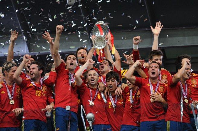 Spain national team players celebrating together with a trophy at Euro 2012, an archive celebration photo